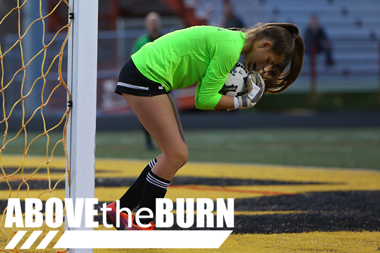 High School Soccer Goalie makes a Save